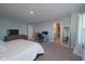 Bright main bedroom with large windows, plush carpet, and an open layout with a workspace at 11663 Winnower, Noblesville, IN 46060