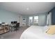 Bright main bedroom with large windows, plush carpet, and an open layout with a workspace at 11663 Winnower, Noblesville, IN 46060