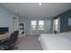Bright main bedroom with large windows, plush carpet, and an open layout with a workspace at 11663 Winnower, Noblesville, IN 46060