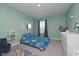 bedroom with Paw Patrol bedding, blue-green walls, and playful decor creating a fun and inviting space at 11663 Winnower, Noblesville, IN 46060
