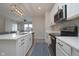 Well-lit kitchen featuring stainless steel appliances, an island with sink, and sleek cabinetry at 11663 Winnower, Noblesville, IN 46060