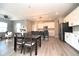 Modern kitchen with stainless steel appliances, white cabinetry, and a spacious center island with seating at 11663 Winnower, Noblesville, IN 46060