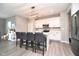 Stylish kitchen island with seating, stainless steel appliances, and modern lighting fixtures at 11663 Winnower, Noblesville, IN 46060
