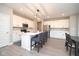 Open kitchen with white cabinets, stainless steel appliances, and a large island with seating at 11663 Winnower, Noblesville, IN 46060
