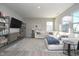 Bright living room featuring a plush white sectional and natural light from the windows at 11663 Winnower, Noblesville, IN 46060