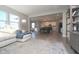 Spacious living room with large windows, open layout, and modern furnishings, perfect for entertaining at 11663 Winnower, Noblesville, IN 46060