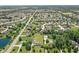 Aerial view of a neighborhood showcasing mature trees, community ponds, and well-maintained lawns at 1439 E Mckenzie Rd, Greenfield, IN 46140