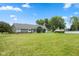 Sprawling backyard featuring lush green grass, mature trees, screened-in porch, and an above-ground swimming pool at 1439 E Mckenzie Rd, Greenfield, IN 46140