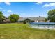 Expansive backyard with green grass, an above-ground swimming pool, and mature trees at 1439 E Mckenzie Rd, Greenfield, IN 46140