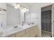 Well-lit bathroom with double sink vanity and tiled shower with curtain at 1439 E Mckenzie Rd, Greenfield, IN 46140