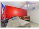 Comfortable bedroom with a gray comforter, orange ceiling fan, and a crib at 1439 E Mckenzie Rd, Greenfield, IN 46140