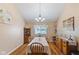 A well-lit dining room with hardwood floors, traditional furniture, and tasteful decor at 1439 E Mckenzie Rd, Greenfield, IN 46140
