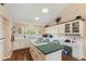Open kitchen with an island cooktop, white cabinets, and hardwood floors at 1439 E Mckenzie Rd, Greenfield, IN 46140