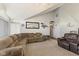 Cozy living room with neutral carpeting and comfortable couches and vaulted ceilings at 1439 E Mckenzie Rd, Greenfield, IN 46140