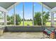 A screened-in porch with outdoor seating offers a view of the expansive backyard at 1439 E Mckenzie Rd, Greenfield, IN 46140