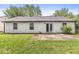 Back exterior of home with vinyl siding, sliding glass door, and patio overlooking a grassy yard at 1540 Brook Pointe Dr, Indianapolis, IN 46234