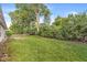 The large, fenced backyard features lush landscaping providing privacy and charm to the property at 1540 Brook Pointe Dr, Indianapolis, IN 46234
