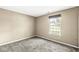 A quiet bedroom with carpet flooring and natural light from a single window at 1540 Brook Pointe Dr, Indianapolis, IN 46234