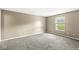 Bright, carpeted bedroom with a large window and neutral-colored walls at 1540 Brook Pointe Dr, Indianapolis, IN 46234