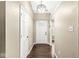 A welcoming foyer with hardwood floors, a white front door and classic lighting fixture at 1540 Brook Pointe Dr, Indianapolis, IN 46234