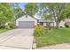 Inviting single-story home with a well-manicured lawn and attached garage provides great curb appeal at 1540 Brook Pointe Dr, Indianapolis, IN 46234