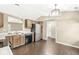Bright kitchen and dining area featuring wood floors, stainless steel appliances, and modern lighting at 1540 Brook Pointe Dr, Indianapolis, IN 46234