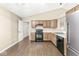 Open kitchen featuring wooden cabinets, modern appliances, and hardwood style flooring at 1540 Brook Pointe Dr, Indianapolis, IN 46234