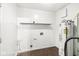 Functional laundry room includes a utility sink, shelving, washer/dryer hookups and durable flooring at 1540 Brook Pointe Dr, Indianapolis, IN 46234