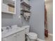 Bathroom features a sink, toilet, and a shower with industrial style shelves for storage at 1603 S Morgantown Rd, Greenwood, IN 46143