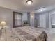 Spacious bedroom features wood floors, window, a fish tank, and access to the ensuite bathroom at 1603 S Morgantown Rd, Greenwood, IN 46143