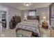 A well lit bedroom offers a neutral palate and laminate floors at 1603 S Morgantown Rd, Greenwood, IN 46143
