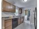 This kitchen with tile floor offers ample storage and easy access to the laundry at 1603 S Morgantown Rd, Greenwood, IN 46143