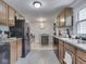 An open kitchen features tile flooring and direct access to a dining room at 1603 S Morgantown Rd, Greenwood, IN 46143