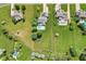 Aerial view of a neighborhood with lush green lawns and mature trees surrounding beautiful homes at 1682 S Fox Cove Blvd, New Palestine, IN 46163
