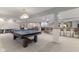 Finished basement featuring a bar, ping pong table, and a cozy entertainment area with a fireplace at 1682 S Fox Cove Blvd, New Palestine, IN 46163