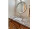 Stylish bathroom vanity featuring a granite countertop, unique mirror, and modern fixtures at 1682 S Fox Cove Blvd, New Palestine, IN 46163