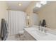 Bathroom with bright white vanity, walk-in shower with curtain, and tiled floors at 1682 S Fox Cove Blvd, New Palestine, IN 46163