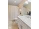 Bathroom with bright white vanity, walk-in shower with curtain, and tiled floors at 1682 S Fox Cove Blvd, New Palestine, IN 46163