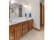 Bathroom featuring double vanity with stone countertop and wood cabinets, with tile floor at 1682 S Fox Cove Blvd, New Palestine, IN 46163
