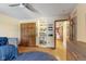 Bedroom with wood floors, blue bedding, and a window with natural light at 1682 S Fox Cove Blvd, New Palestine, IN 46163