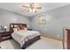 Cozy bedroom with neutral tones, complemented by a ceiling fan and natural light at 1682 S Fox Cove Blvd, New Palestine, IN 46163