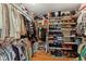 Walk-in closet with built-in shelving and a variety of clothing, shoes and accessories at 1682 S Fox Cove Blvd, New Palestine, IN 46163