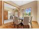 Dining room with hardwood floors, modern chandelier, and neutral wall decor at 1682 S Fox Cove Blvd, New Palestine, IN 46163
