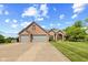 Beautiful brick home featuring a three car garage and a meticulously manicured lawn at 1682 S Fox Cove Blvd, New Palestine, IN 46163