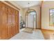 Welcoming foyer with tiled flooring, arched doorway, closet, and elegant lighting at 1682 S Fox Cove Blvd, New Palestine, IN 46163