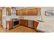 Kitchen featuring stainless steel appliances, granite countertops, wood cabinets and subway tile backsplash at 1682 S Fox Cove Blvd, New Palestine, IN 46163