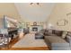 Cozy living room with fireplace, hardwood floors, and vaulted ceilings at 1682 S Fox Cove Blvd, New Palestine, IN 46163