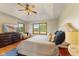 Bedroom featuring vaulted ceiling, hardwood floors, and large window with backyard views at 1682 S Fox Cove Blvd, New Palestine, IN 46163