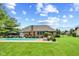 Spacious backyard featuring a sparkling pool, lounge chairs, and meticulous landscaping at 1682 S Fox Cove Blvd, New Palestine, IN 46163