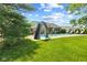 Backyard featuring an in-ground pool with a slide, lounge chairs, and a beautifully landscaped lawn at 1682 S Fox Cove Blvd, New Palestine, IN 46163